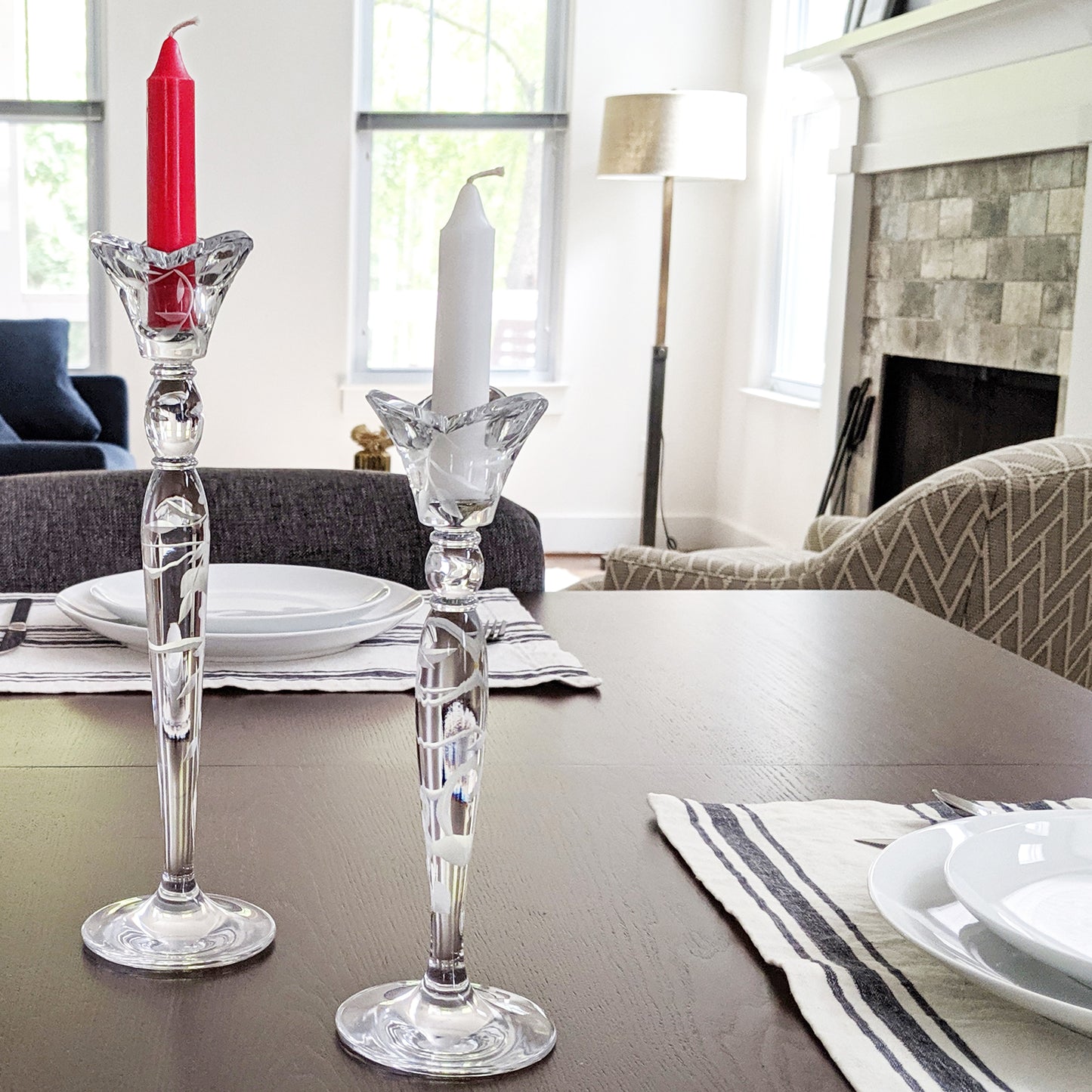 Image, Red and white candles in crystal candle holders, displayed on dining table.