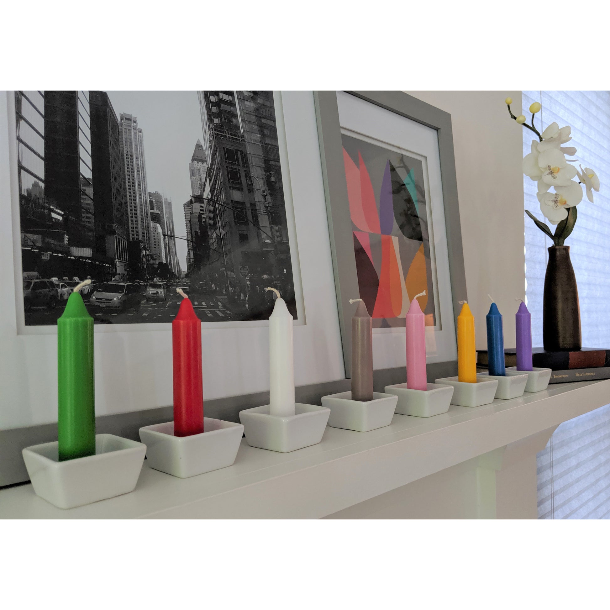 Image, angled view of multi colored candles displayed on mantle.