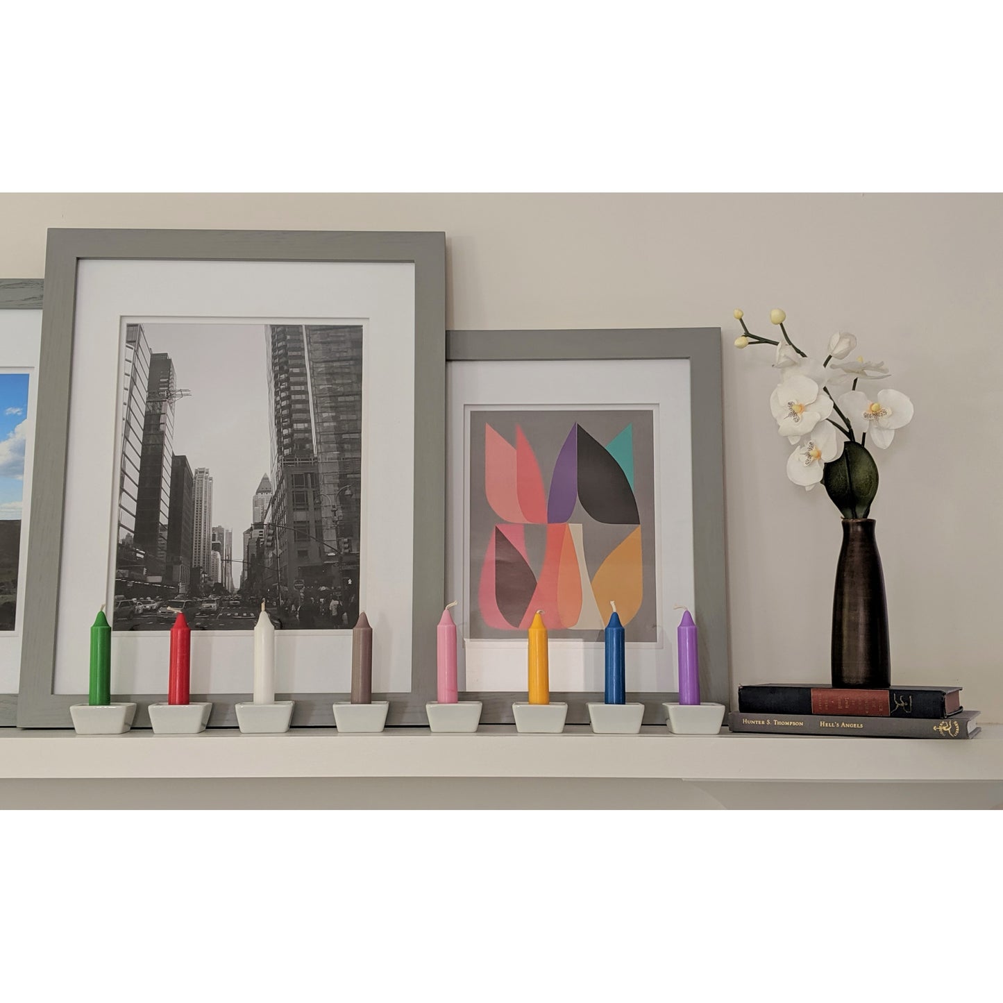 Image, multi colored candles displayed on mantle.