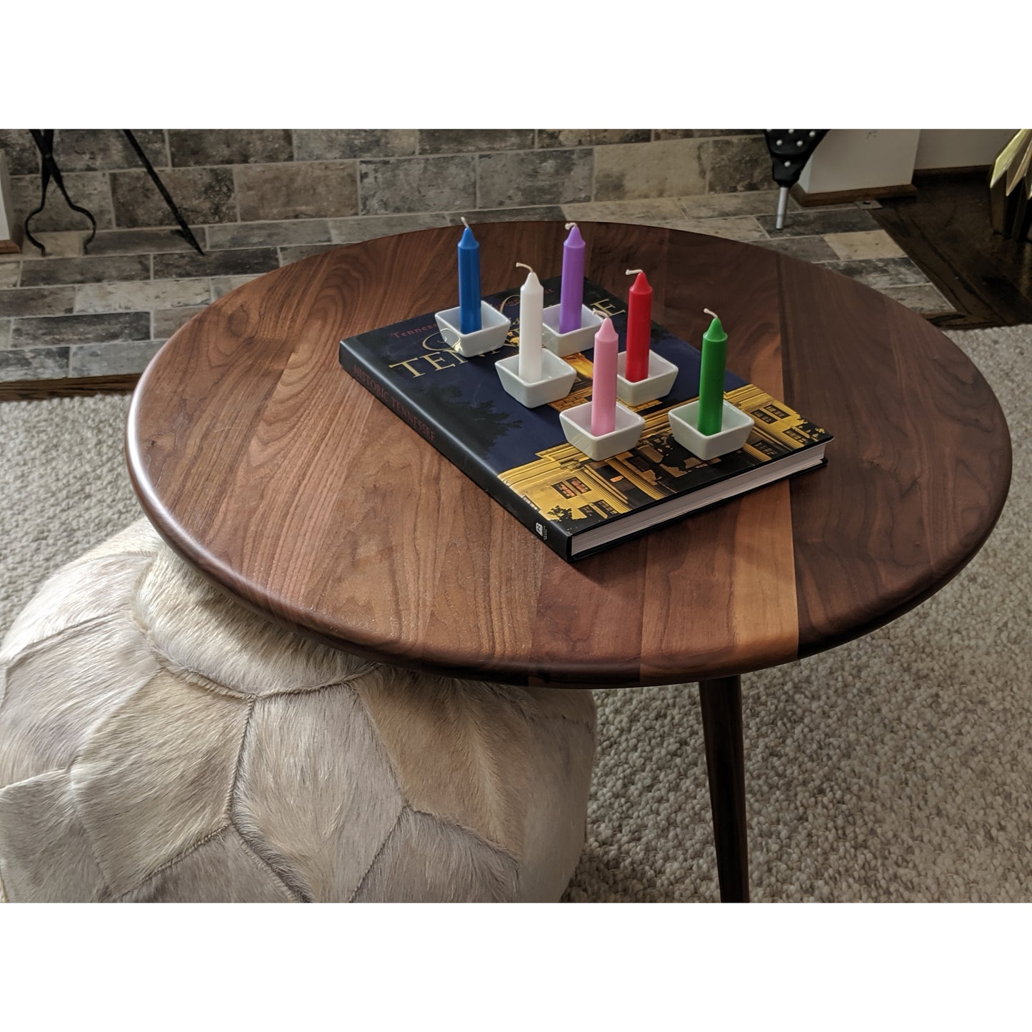 Image, multi colored candles displayed on coffee table.